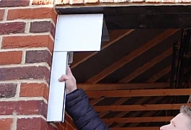Between Fit: roller box mounted within the opening on the face of the brickwork