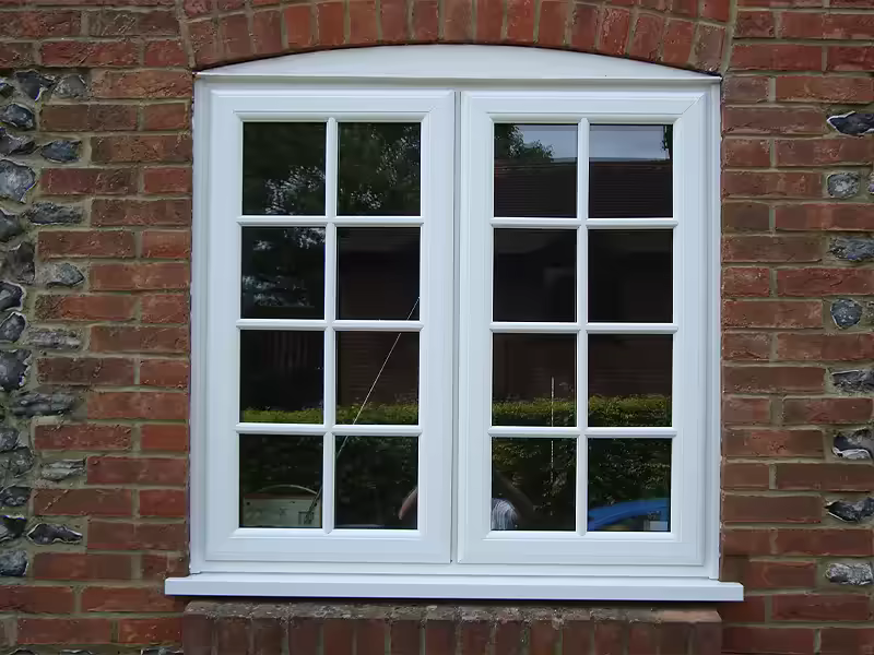 White standard casement window with decorative astragal bars